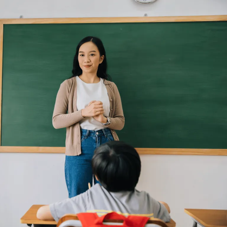 teacher teaching in front of students 